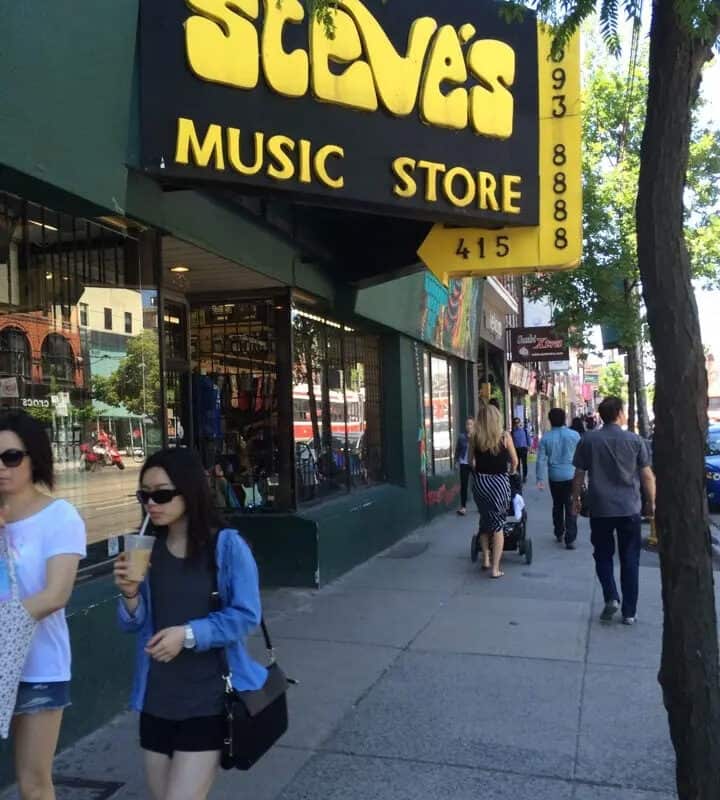 Exterior view of Steve's Music Store on a busy street with pedestrians.